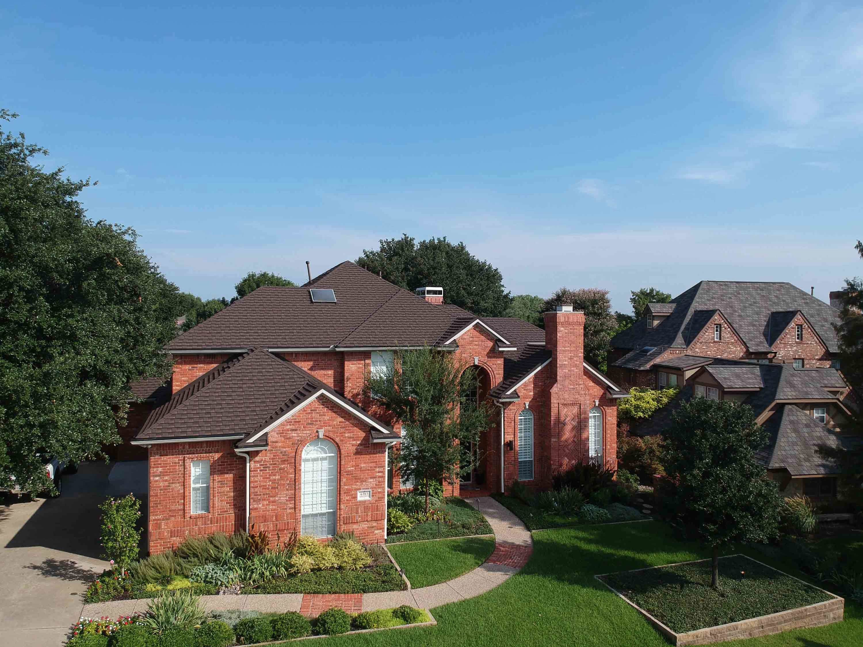 Tilcor metal shingles in Barkwood on a home, manufacturer example